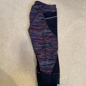 Athleta leggings, navy with multi color stripes. Pockets on legs and back. 2X
